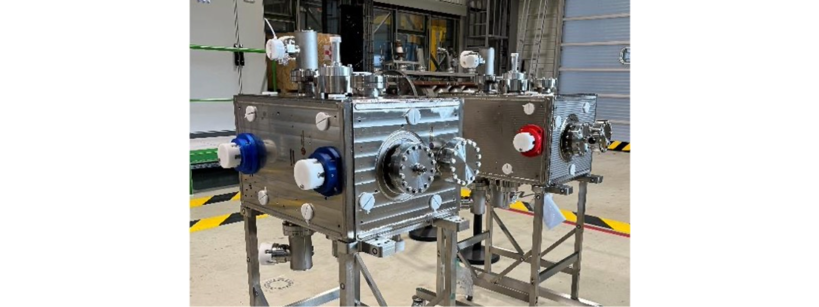 two boxy pieces of equipment with cylindrical appendages