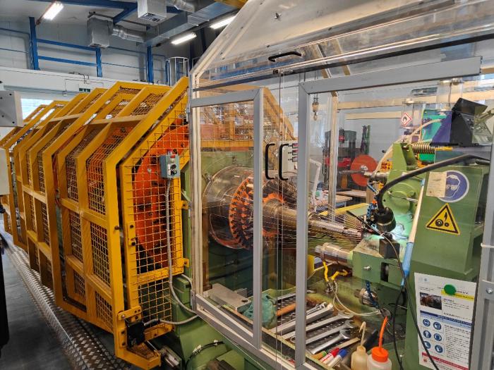big machine with yellow cage, and a rotating inner section