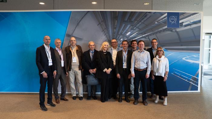 group photo in front of an image of a tunnel